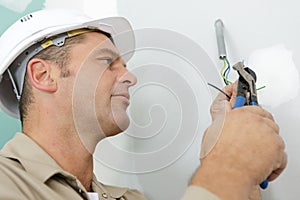 electrician cutting cables in construction site