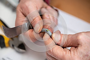 Electrician cutting the insulation of a power cable