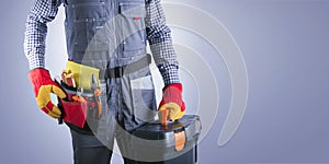 Electrician With Electric Tools Against Light Gray Background With Place For Text.