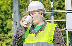 Electrician Engineer drink coffee in a workplace