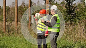 Electrician Engineer explains to worker assigned work