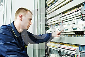 Electrician engineer inspector in front of fuseboard