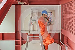 Electrician engineer perform maintenance checking service at solar combiner and control circuit box photo
