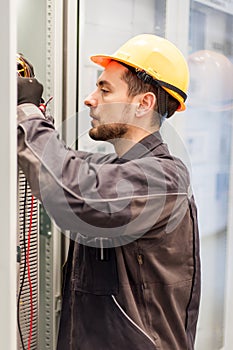 Electrician engineer tests electrical installations on relay pro