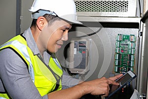 Electrician engineer touch the tablet and find the information how to operate the generator