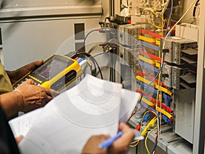 Electrician engineer uses a multimeter