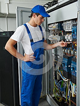 electrician engineer worker checks electrical equipment for repair