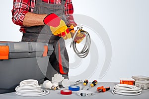 Electrician engineer works with electric cable wires of house. Electrical equipment.