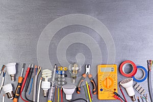 Electrician equipment on metalic background, top view