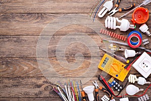 Electrician equipment on wooden background with copy space photo