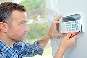 Electrician fitting intrusion alarm