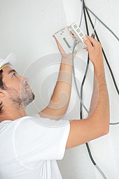 Electrician fitting thermostat system