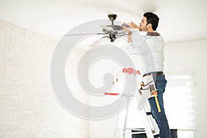 Electrician fixing a ceiling fan