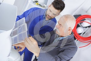 electrician fixing electrical devices with different tools