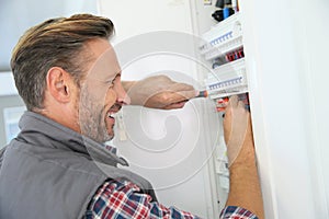 Electrician fixing home panel box photo