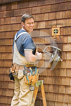 Electrician fixing outdoor light photo