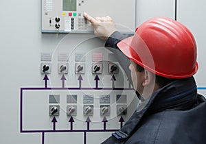Electrician give command in power plant control center