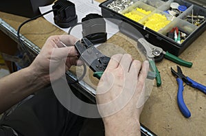 Electrician hands stripping wire connections with a stripper