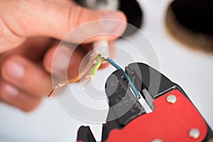 Electrician hands stripping wires photo