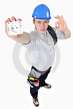 Electrician holding an electrical socket