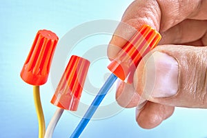 Electrician holds wire connectors on wires