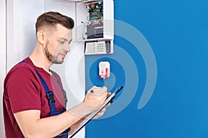 Electrician inspecting alarm system