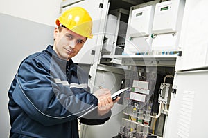 Electrician inspector checking electric meter data photo