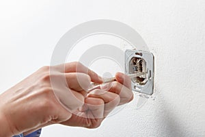 Electrician installing AC power socket