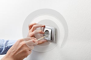 Electrician installing AC power socket