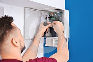 Electrician installing alarm system