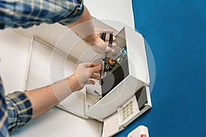 Electrician installing alarm system