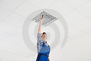 Electrician Installing Ceiling Light