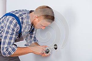 Electrician installing electrical socket