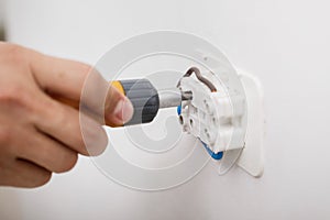 Electrician installing electrical socket