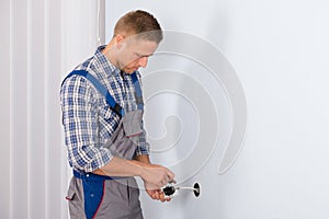 Electrician installing electrical socket