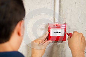 Electrician installing fire alarm