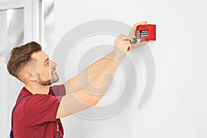 Electrician installing fire alarm system