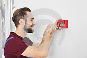 Electrician installing fire alarm system