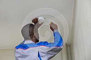 Electrician Installing Fire Sensor photo