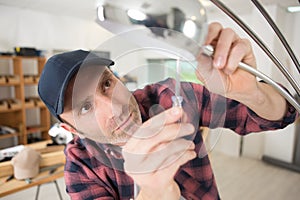 electrician installing light bulb on ceiling