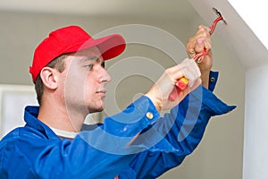 Electrician installing lights