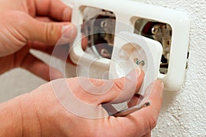 Electrician installing socket