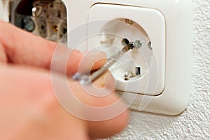 Electrician installing socket photo