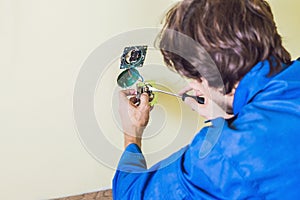 Electrician Installing Socket In New House