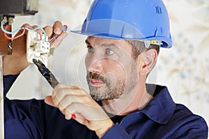 Electrician installing socket in new house