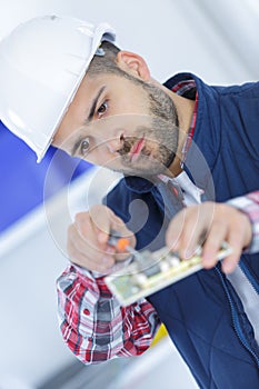 electrician installing socket in new house