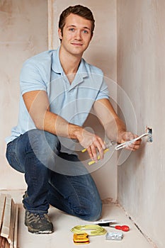 Electrician Installing Socket In New House