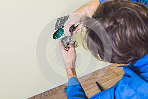 Electrician Installing Socket In New House