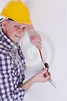 Electrician installing a switch