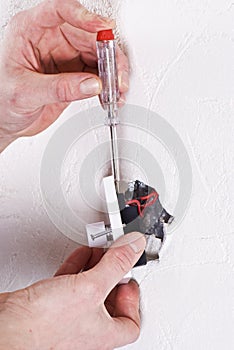 Electrician installing a switch